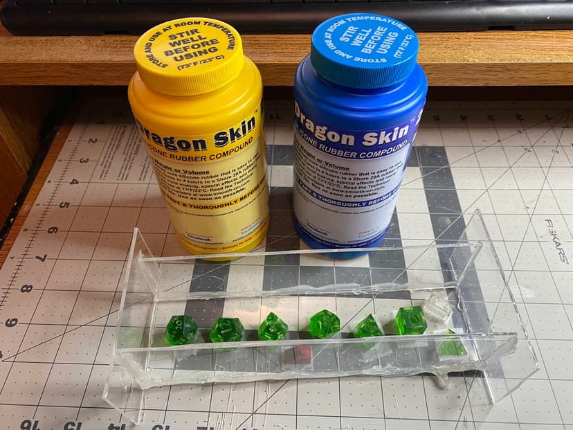 Here are a set of master dice in the mold container just before adding silicone.